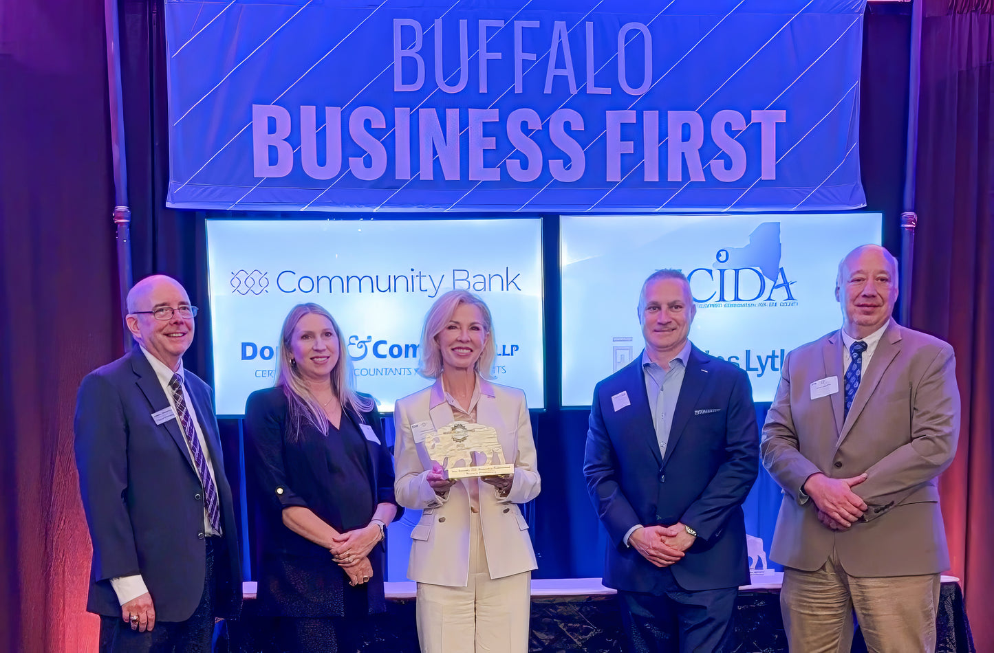 image of Lina accepting her "Women in Manufacturing" award from Buffalo Business First