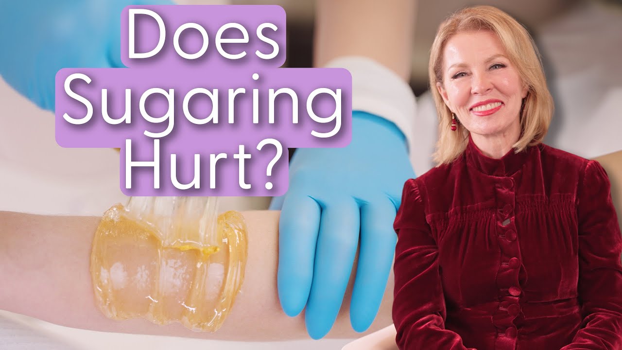 title screen from a YouTube video with Lina in a red jacket, an image of sugaring in the background and the text "Does Sugaring Hurt?"