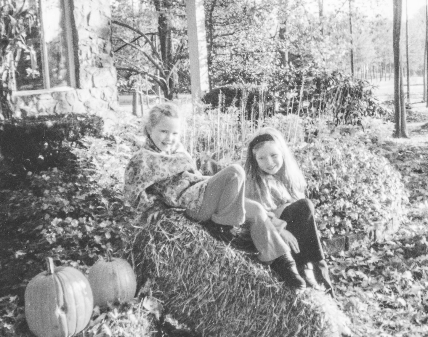 black and white image of Lina's two young daughters posing outside