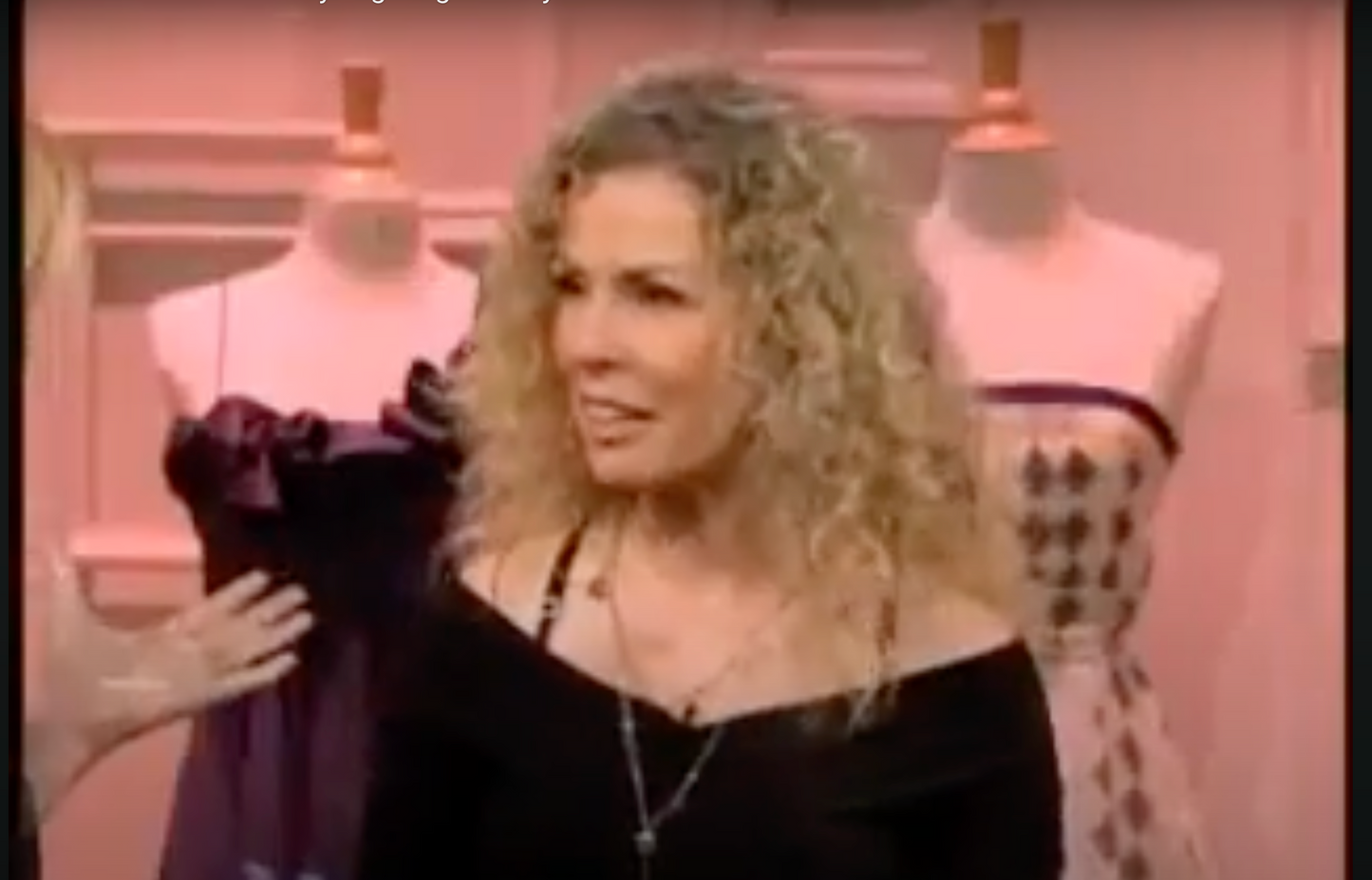 screenshot of Lina wearing a black top on an LA TV show from the late 2000s